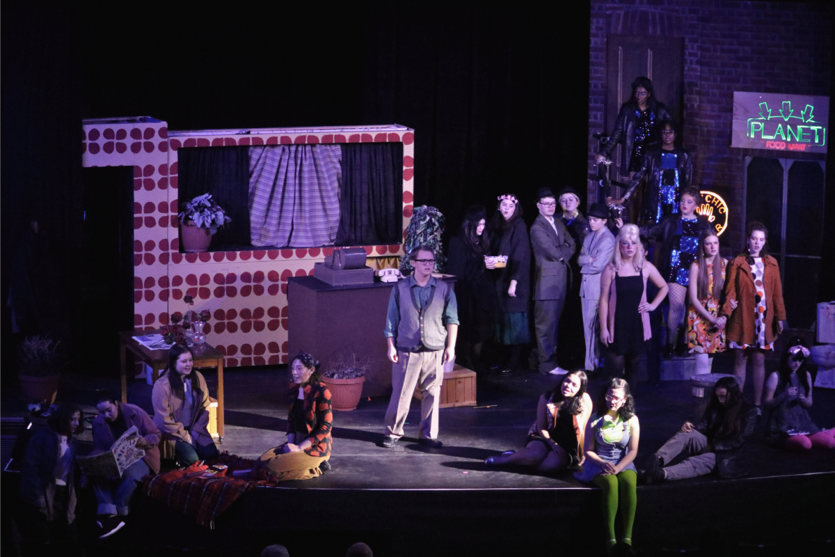 University of Guelph student ensemble performs on stage in a production of Little Shop of Horrors at War Memorial Hall at U of G.